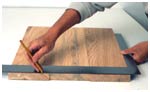 Remove the clamps and use a large square to mark the edges before trimming them with a saw